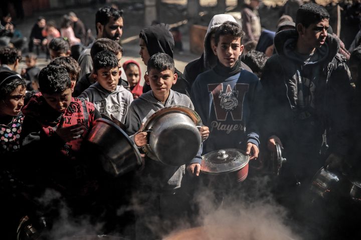 Palestinians gather to collect aid food in Beit Lahia, in the northern Gaza Strip, on February 26, 2024, amid continuing battles between Israel and the Palestinian militant group Hamas.