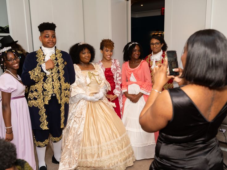Aaliyah takes a photo of Lekia, Amechi, Min, Eva, Alimony and Ellem, all students of the Harlem School of the Arts, as they prepare for the 60th Anniversary Gala held at Manhattan's Ziegfeld Ballroom in New York on Monday, May 20, 2024.