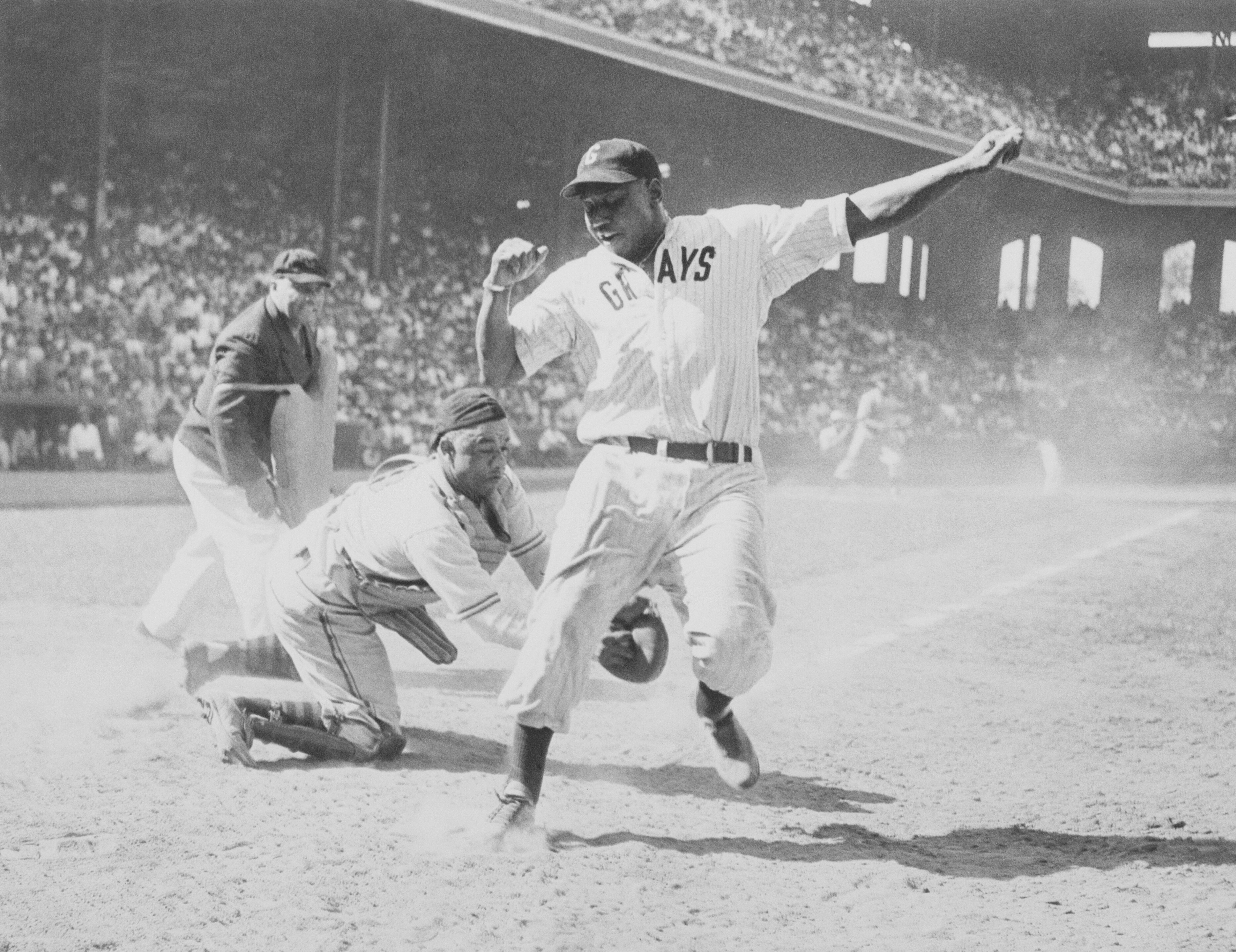 Josh Gibson gets tagged out by the catcher during 1944's East-West All Star Negro baseball game at Chicago's Comiskey Park. Gibson will now hold the record for best single-season batting average.