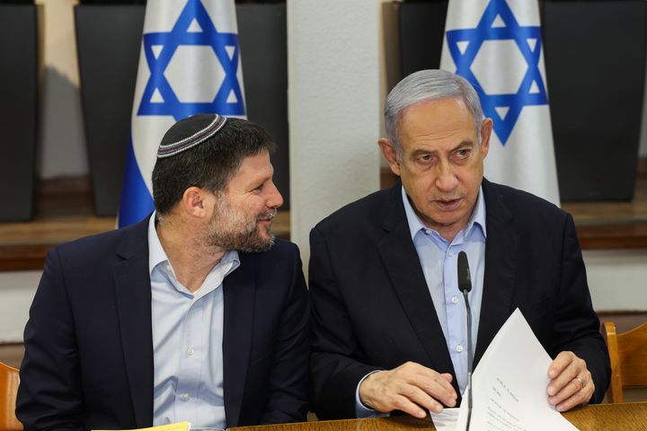 Israeli Prime Minister Benjamin Netanyahu (right) speaks with Minister of Finance Bezalel Smotrich on Jan. 7 during a weekly cabinet meeting at the Defense Ministry in Tel Aviv.