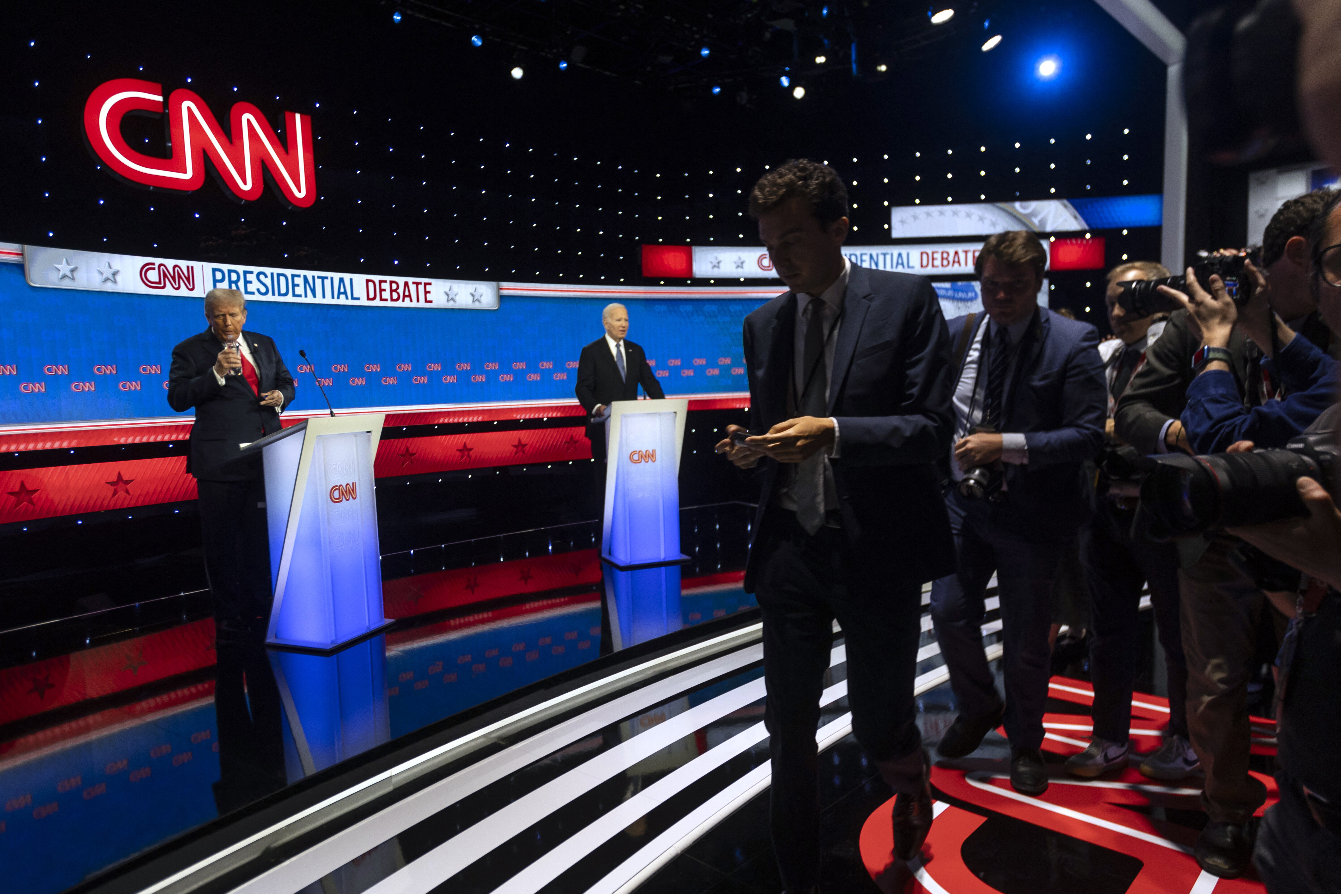 Former President and Republican presidential candidate Donald Trump takes a drink of water next to President Joe Biden as the press exits the debate stage during the first presidential debate of the 2024 elections at CNN's studios in Atlanta, Georgia, on June 27, 2024. (Photo by CHRISTIAN MONTERROSA/AFP via Getty Images)