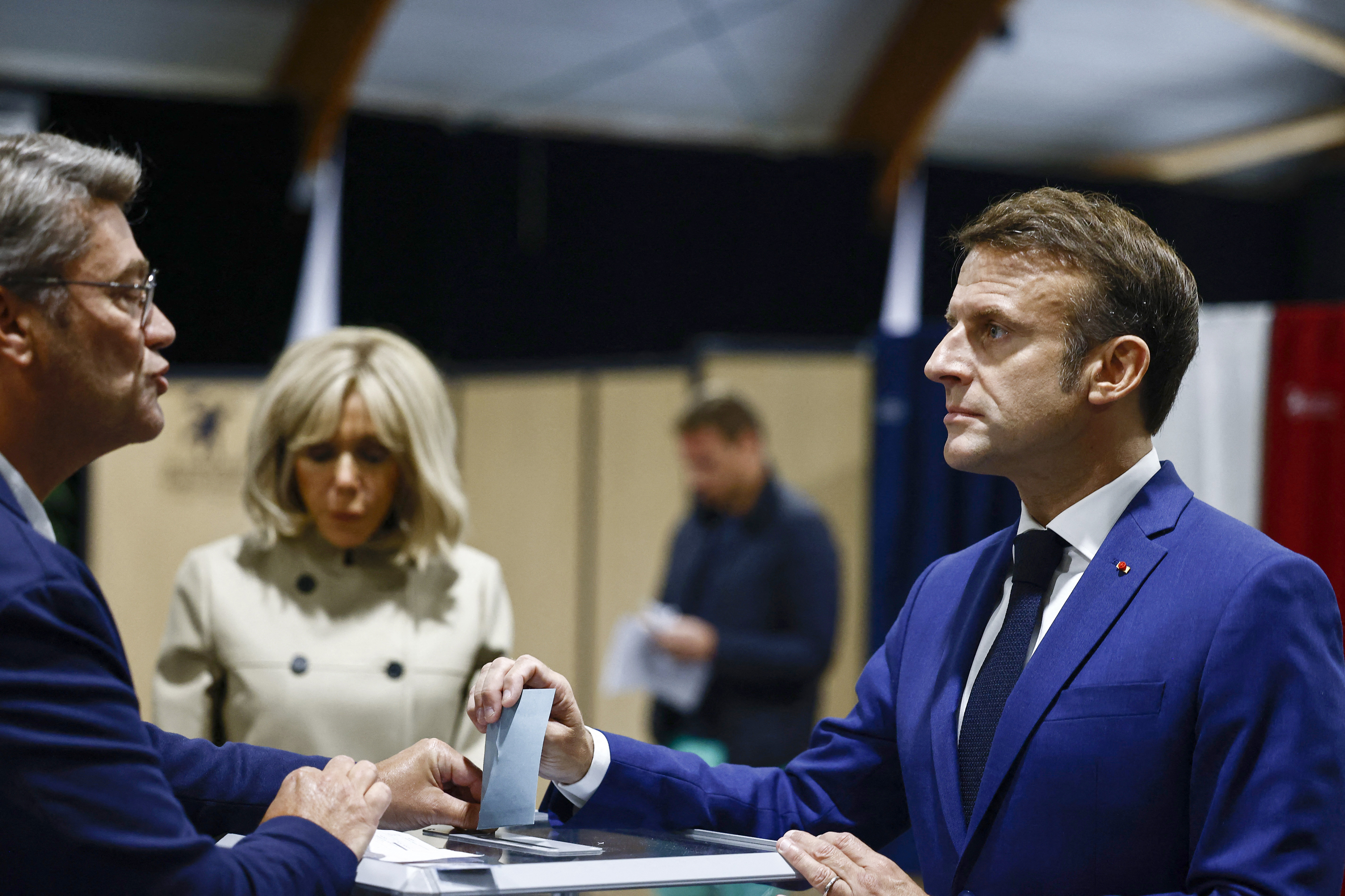 French President Emmanuel Macron, right, casts his ballot to vote in the first round of the early French parliamentary election, in Le Touquet-Paris-Plage, northern France, Sunday, June 30, 2024. (Yara Nardi, Pool via AP)