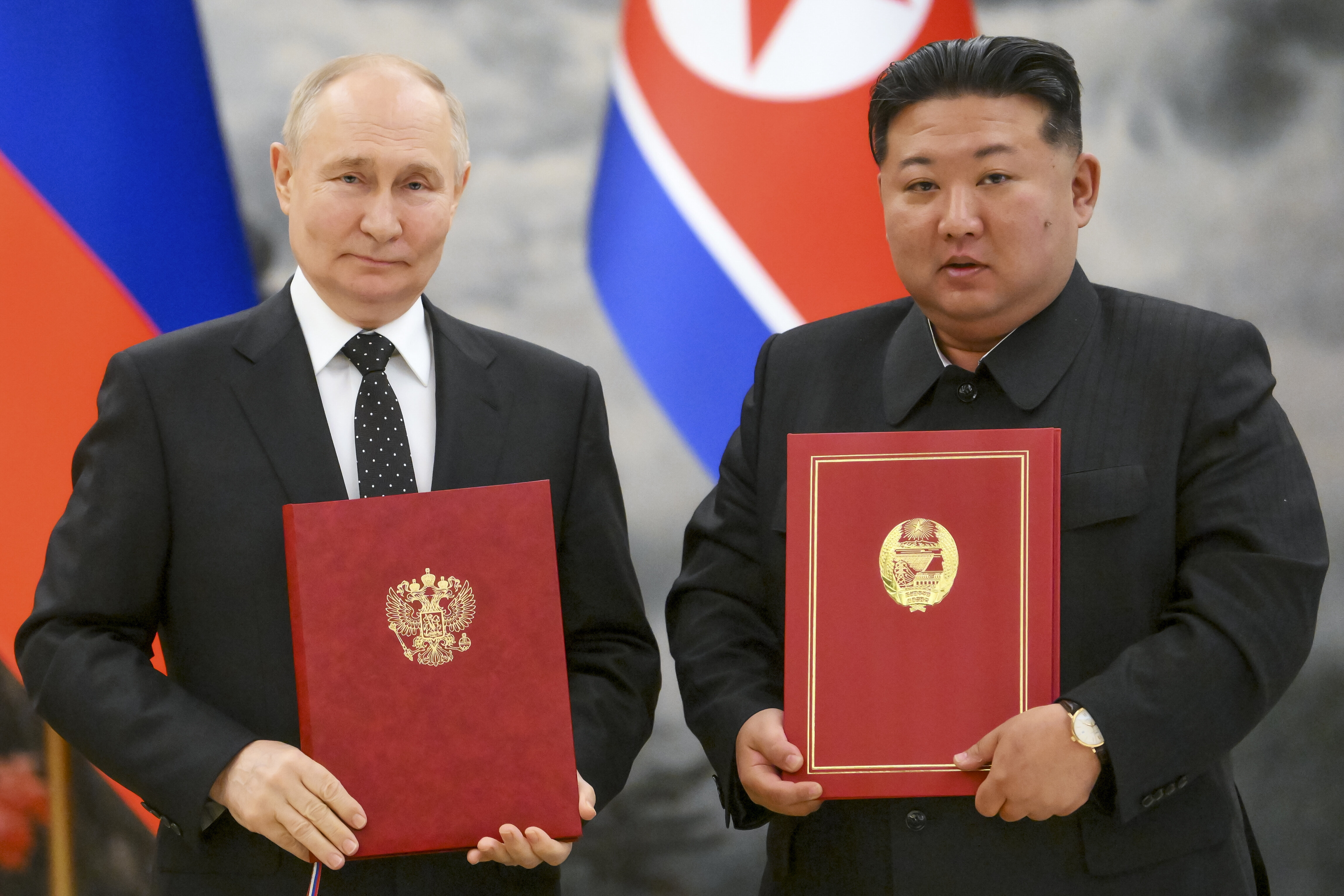 Russian President Vladimir Putin, left, and North Korea's leader Kim Jong Un pose for a photo during a signing ceremony of the new partnership in Pyongyang, North Korea, on June 19, 2024. 