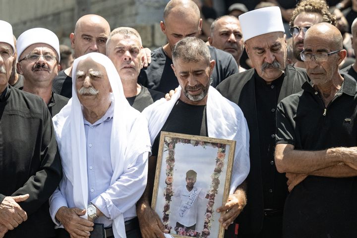 Thousands attend the funeral ceremony for the 12 youths killed in a rocket attack on the Druze town of Majdal Shams in Israeli-occupied Golan Heights on July 28, 2024. Israel has blamed Hezbollah for the attack and has since launched its own attacks on Lebanon, but the militant group has denied responsibility.