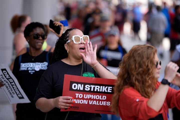 A demonstrator chants while picketing in support of the National Education Association Staff Organization outside the Pennsylvania Convention Center, July 5, in Philadelphia.