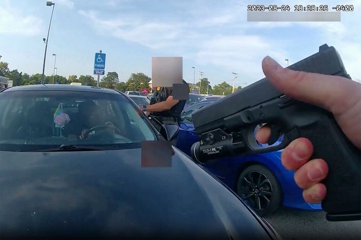 This still image from bodycam video released by the Blendon Township Police on Friday, Sept. 1, 2023, shows an officer pointing his gun at Ta'Kiya Young moments before shooting her through the windshield outside a grocery store in Blendon Township, Ohio, a suburb of Columbus.