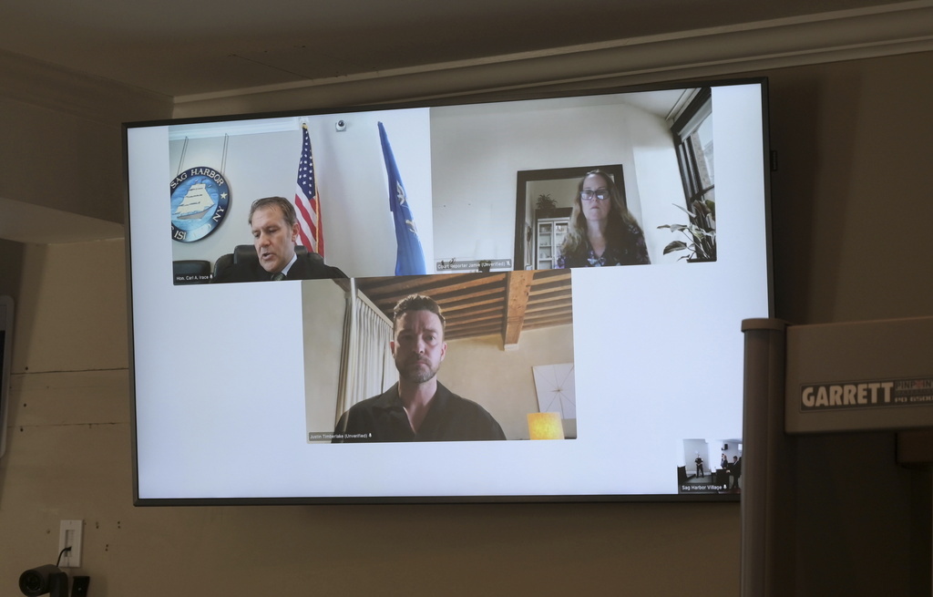 Justin Timberlake, center, appears by video during his arraignment in Sag Harbor Justice Carl Irace's courtroom on Friday, Aug. 2, 2024 in Sag Harbor, N.Y.