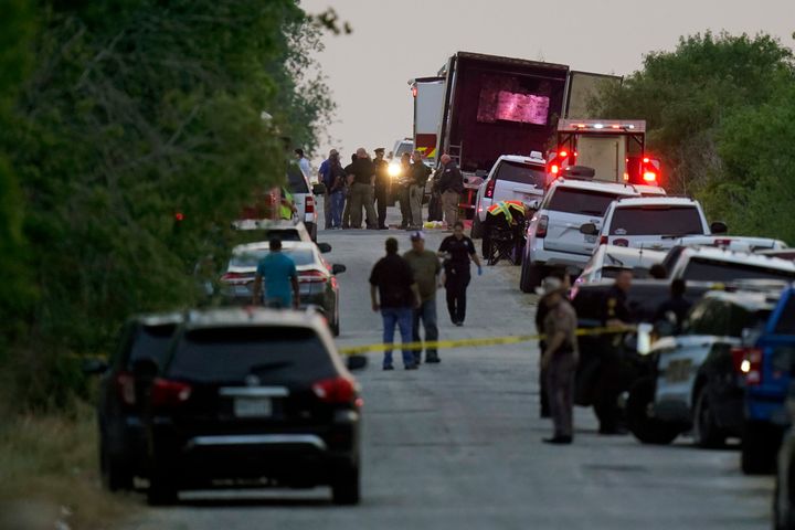 Police and other first responders work the scene where officials say dozens of people have been found dead and multiple others were taken to hospitals with heat-related illnesses after a tractor-trailer containing suspected migrants was found on June 27, 2022, in San Antonio. 