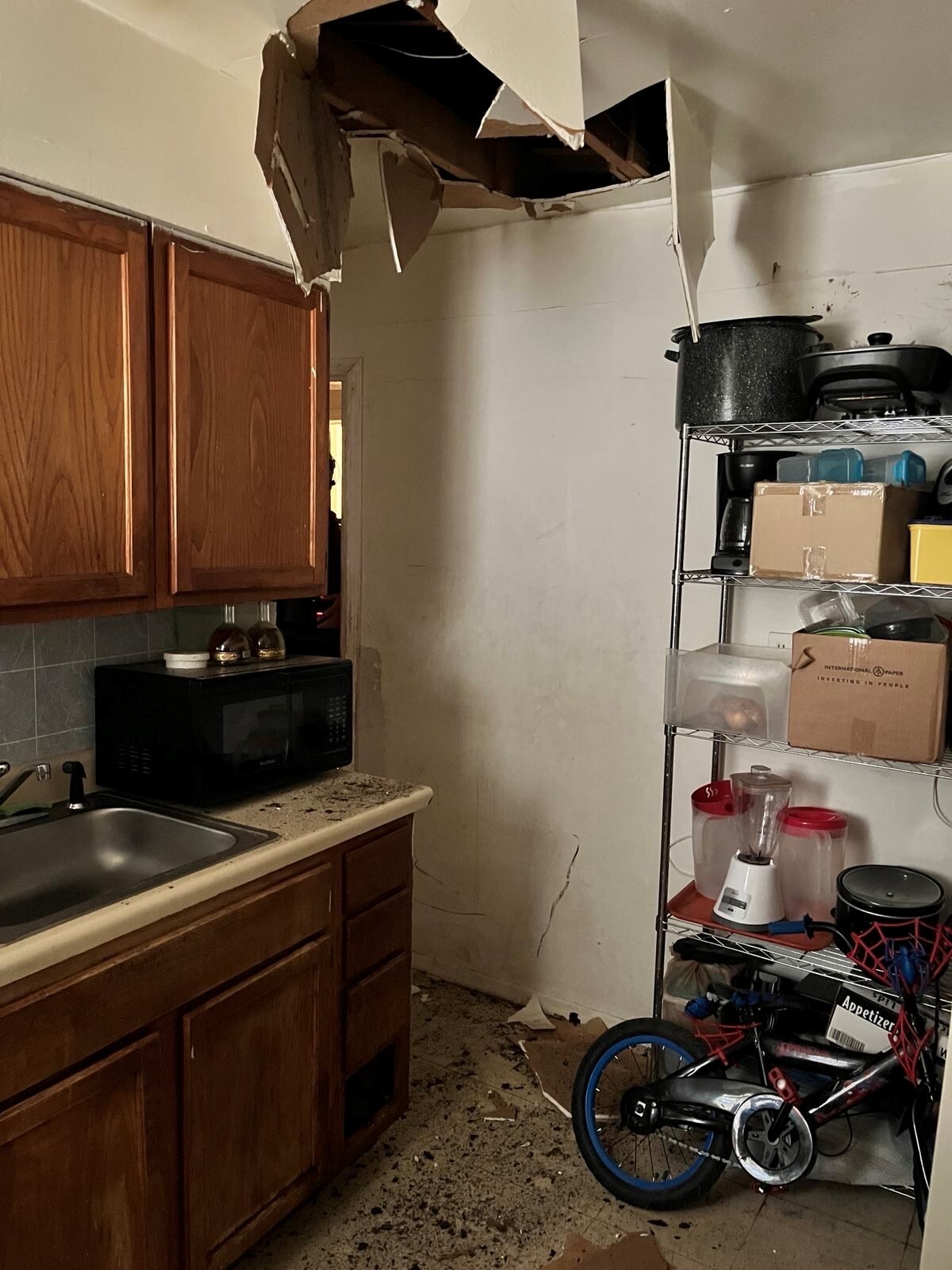 Deario Wilkerson, 20, was arrested on Monday after allegedly falling through this ceiling where he was hiding during a search by U.S. marshals.