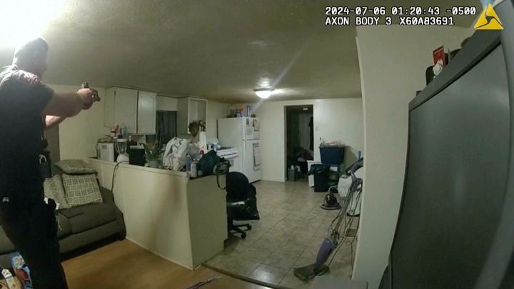 In this image taken from body camera video released by Illinois State Police on Monday, July 22, 2024, former Sangamon County Sheriff’s Deputy Sean Grayson, left, points his gun at Sonya Massey, who called 911 for help, before shooting and killing her inside her home in Springfield, Illinois, on July 6, 2024.