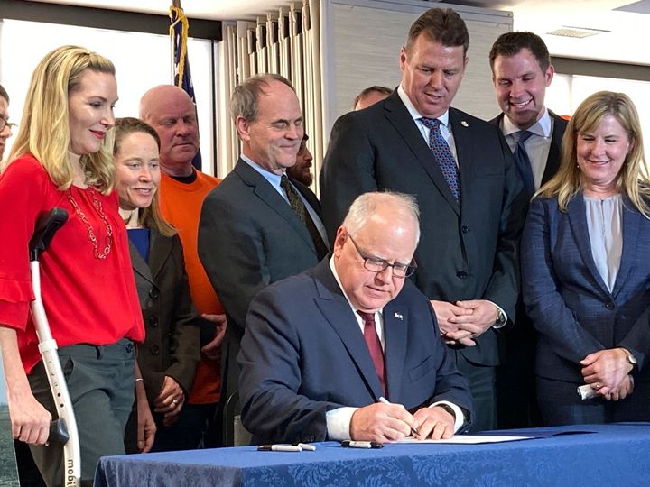 Walz signs a bill into law on Tuesday, Feb. 7, 2023, in Saint Paul, Minnesota, that required Minnesota utilities to get 100% of their electricity from carbon-free sources by 2040. Walz has been called a climate champion by green groups and climate change experts.