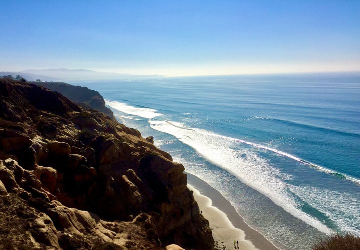 A photo shows the author's view of the Pacific Ocean from the bluffs.