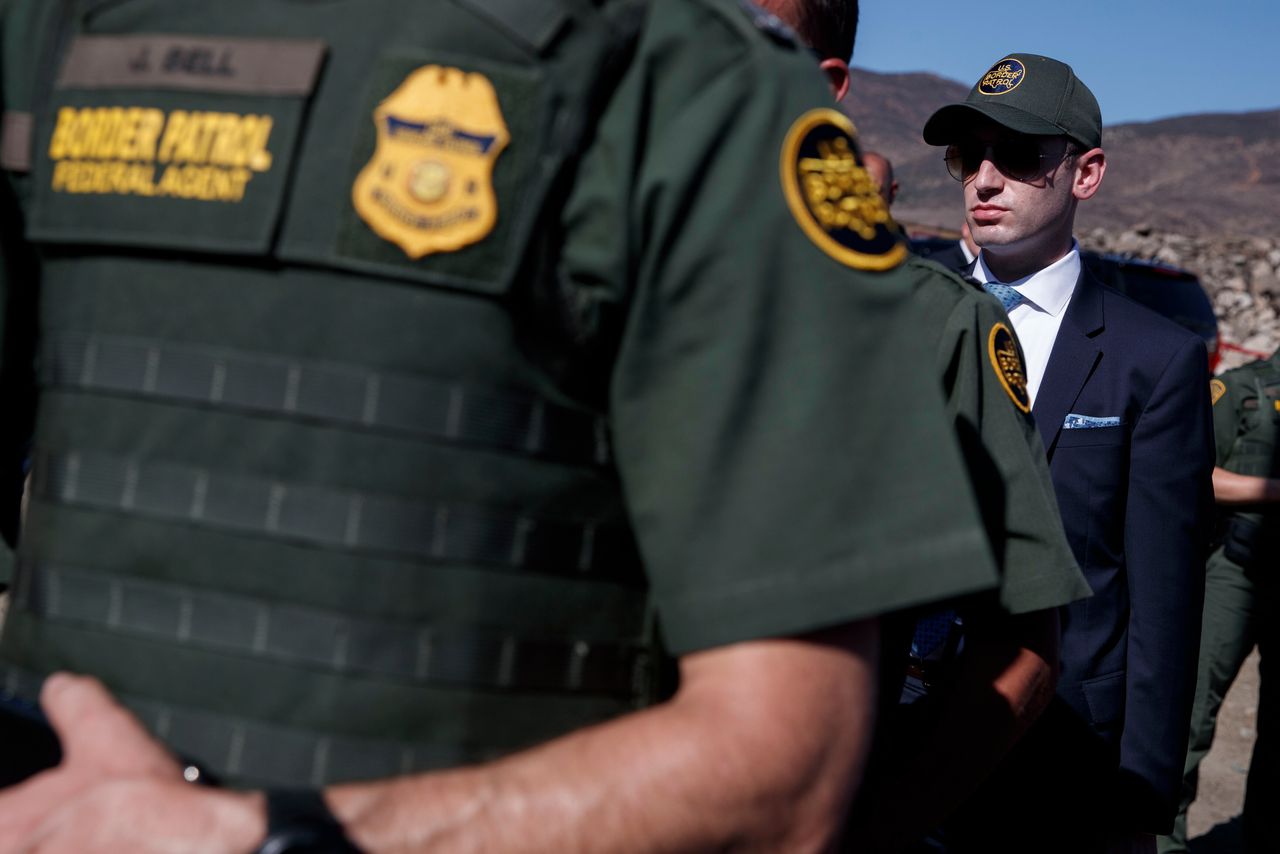 White House senior adviser Stephen Miller watches as President Donald Trump tours a section of the southern border wall, Wednesday, Sept. 18, 2019, in Otay Mesa, Calif. 