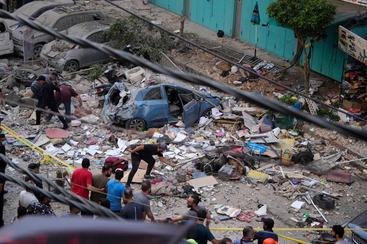 Residents check the site of an Israeli airstrike in Beirut's southern suburbs, Tuesday, Sept. 24, 2024. (AP Photo/Hassan Ammar)