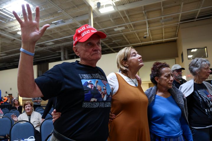 From left, Leonard Andrews, Joanie Andrews, Pamela Hockenberry and Donna Meyer pray before Republican vice presidential nominee Sen. JD Vance, R-Ohio, speaks at a town hall hosted by the Lance Wallnau Show at the Monroeville Convention Center in Monroeville, Pa., Saturday, Sept. 28, 2024. 