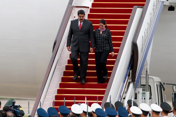 Venezuela's President Nicolas Maduro, left, and first lady Cilia Flores are seen disembarking a plane in China in 2015.