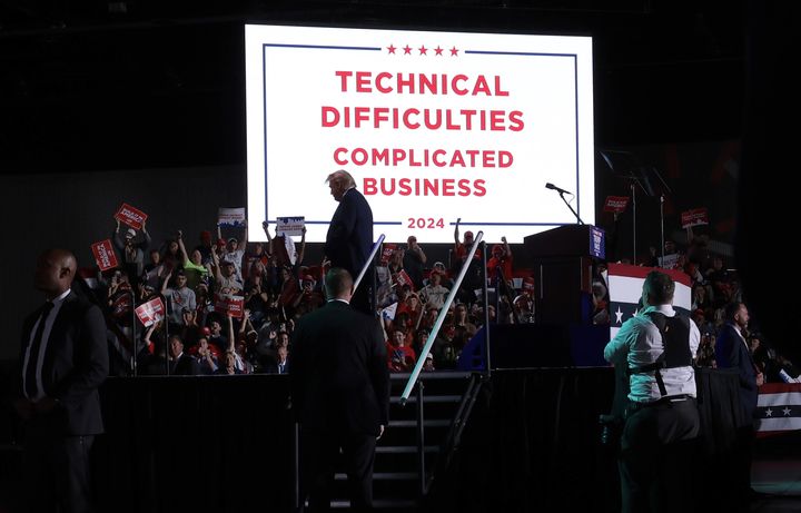 DETROIT, MICHIGAN - OCTOBER 18: Republican presidential nominee, former U.S. President Donald Trump, stands in front of a "technical difficulties" sign after his microphone stopped working during a campaign rally on October 18, 2024, in Detroit, Michigan. There are 17 days remaining until the U.S. presidential election, which will take place on Tuesday, November 5, 2024. (Photo by Win McNamee/Getty Images)