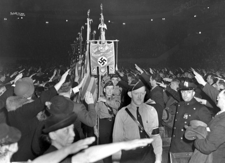 The crowd responds with a Hitler salute as uniformed members of a German-American Bund color guard march at a gathering in New York's Madison Square Garden on Feb. 20, 1939.