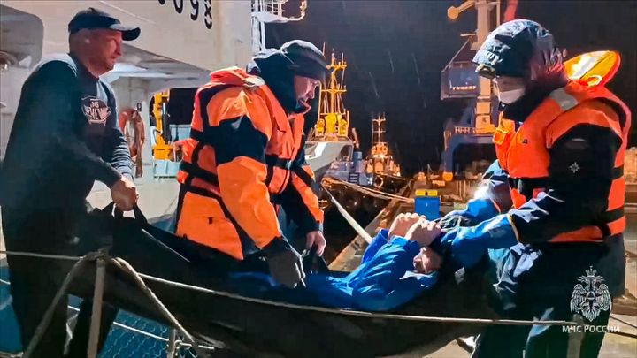 Russian emergency workers pull Mikhail Pichugin ashore after he was rescued by a fishing vessel following 67 days adrift in the Sea of Okhotsk near the village of Ust-Khairuzovo in Kamchatka region of Russian.