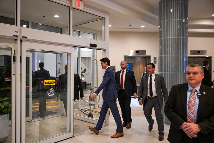 Canadian Prime Minister Justin Treadeau (C) leaves his hotel as he heads to meet US President-elect Donald Trump, in West Palm Beach, Florida, on November 29, 2024. Canadian Prime Minister Justin Trudeau arrived in Palm Beach, Florida, on November 29 for what Canadian and American media said was a meeting with US President-elect Donald Trump at his Mar-a-Lago luxury estate. (Photo by CHANDAN KHANNA / AFP) (Photo by CHANDAN KHANNA/AFP via Getty Images)