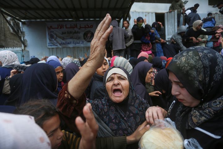 Hundreds of Palestinians wait for their turn in front of a bakery to buy bread under harsh conditions in Deir al-Balah, Gaza Strip, on Nov. 27, 2024. Palestinians are starving due to Israel's attacks on Gaza for more than a year, the closure of border crossings and the limited access to aid.