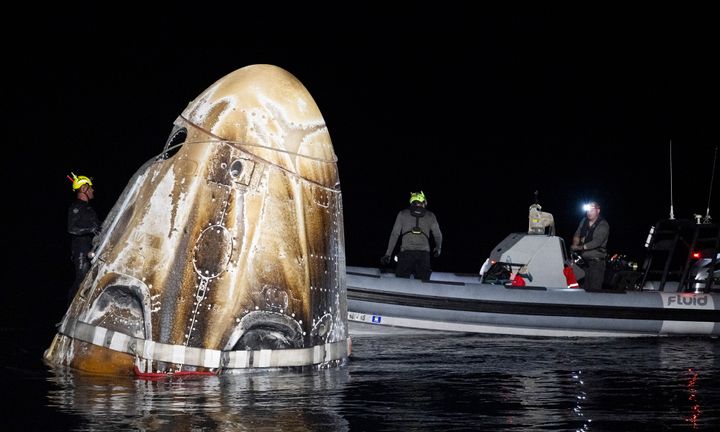 This photo provided by NASA shows support teams work around the SpaceX Dragon Endeavour spacecraft shortly after it landed, in the Gulf of Mexico off the coast of Pensacola, Florida, Friday, Oct. 25, 2024. (NASA/Joel Kowsky via AP)