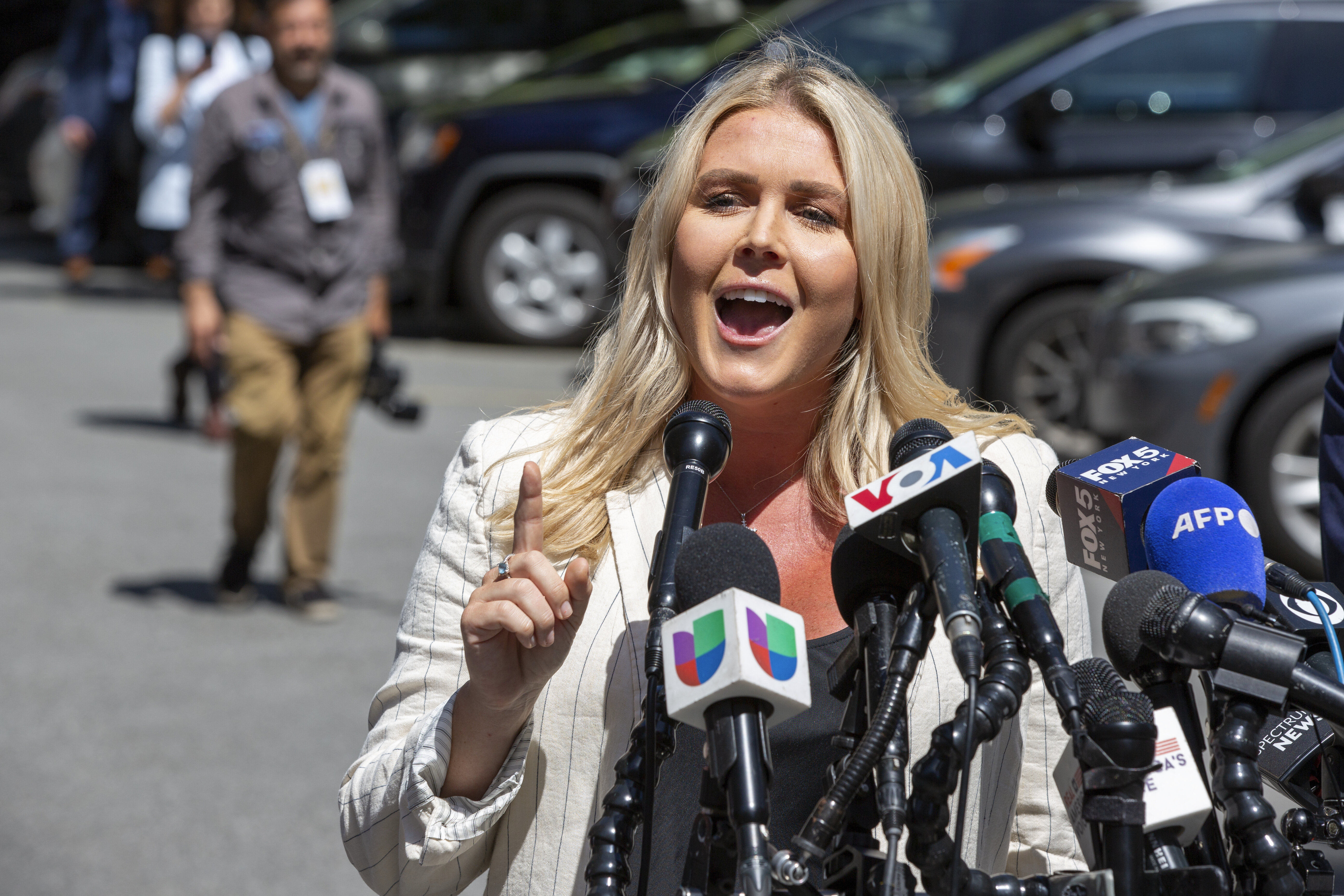 Karoline Leavitt, former President Donald Trump's campaign press secretary, speaks to the news media across the street from Trump's criminal trial in New York, Tuesday, May 28, 2024.