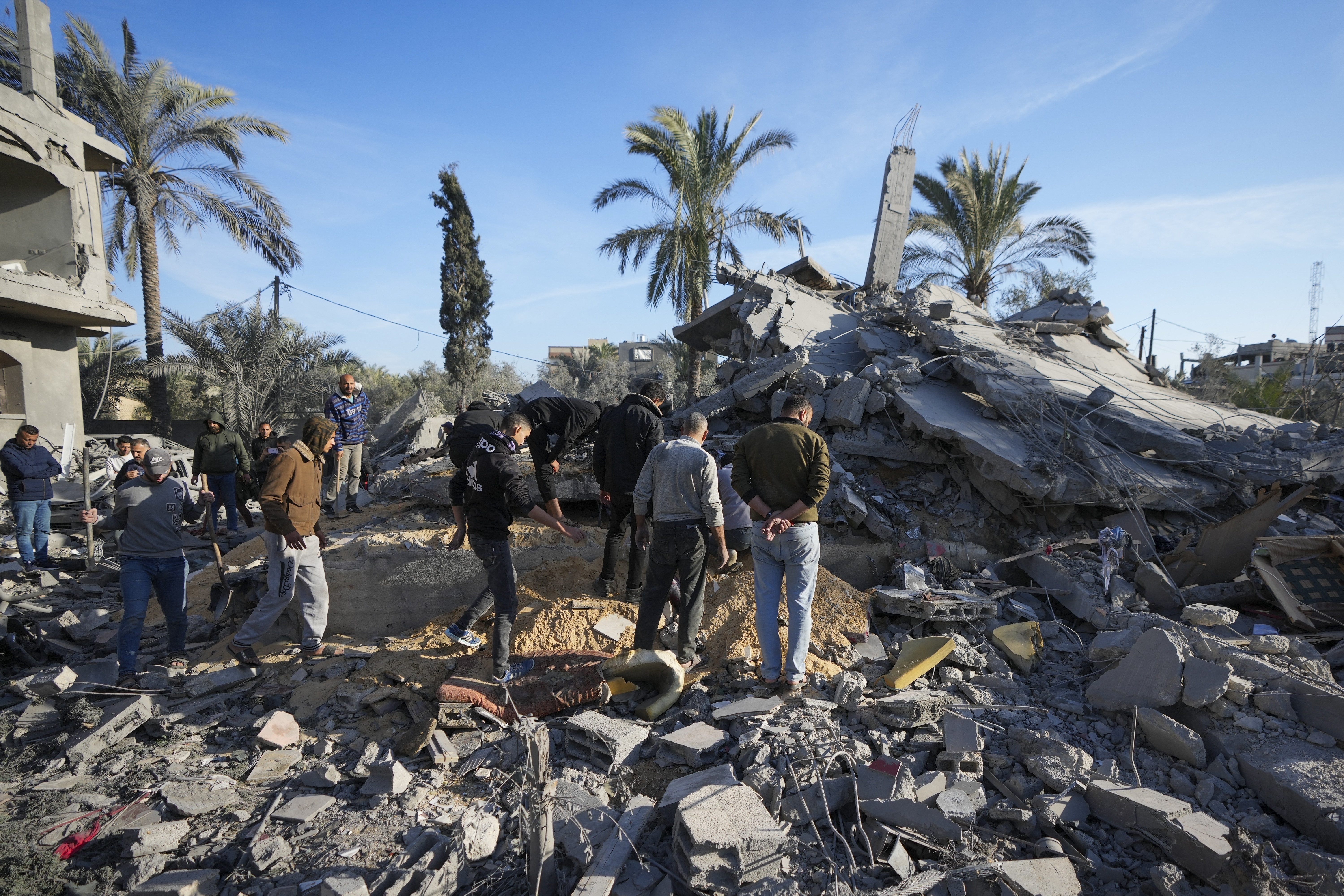 Palestinians look at home destroyed by an Israeli strike late Saturday in Deir al-Balah Sunday, Dec. 22, 2024. At least eight people were killed according to the hospital which received the bodies. (AP Photo/Abdel Kareem Hana)