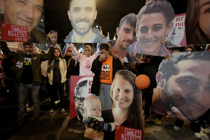 Demonstrators hold portraits of hostages held by Hamas in the Gaza Strip during a protest calling for their immediate release in Tel Aviv, Israel, Saturday Jan. 18, 2025. (AP Photo/Oded Balilty)