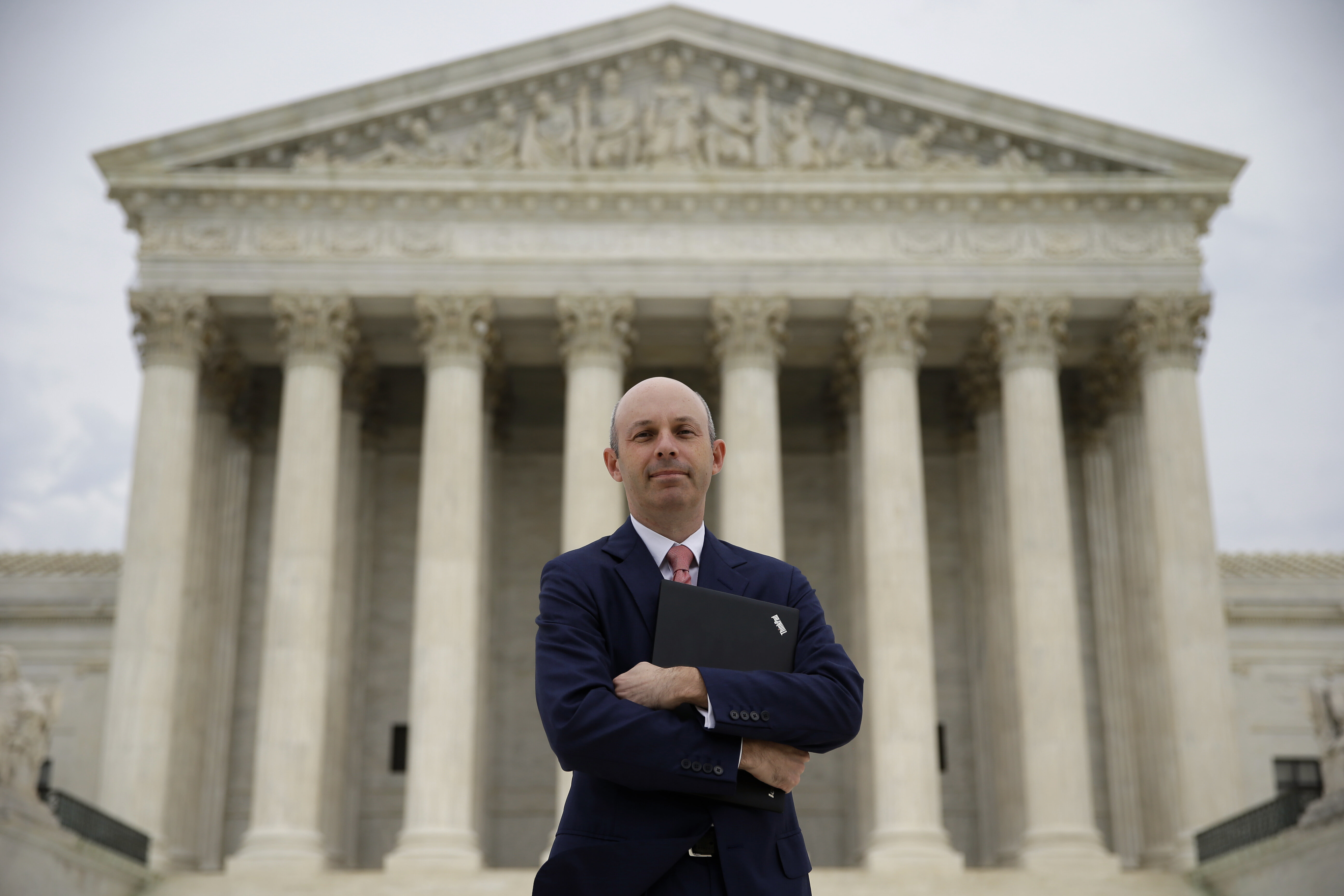 Tom Goldstein, who writes SCOTUSblog.com, poses for a photograph in front of the Supreme Court, Thursday, Oct. 31, 2013, in Washington. 