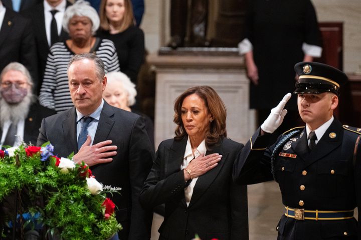 Vice President Kamala Harris and Second Gentleman Doug Emhoff pay their respects to President Jimmy Carter during his lying in state ceremony at the U.S. Capitol Rotunda on Tuesday.