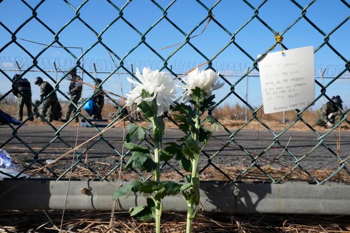 A message of condolences and flowers are seen outside Muan International Airport in South Korea.