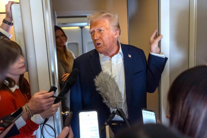 President Donald Trump speaks to reporters aboard Air Force One as he travels from Las Vegas to Miami on Saturday, Jan. 25, 2025. (AP Photo/Mark Schiefelbein)