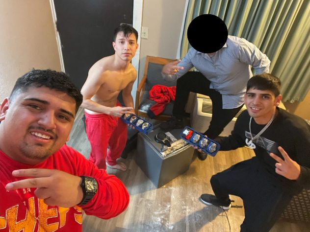 Pablo Zuniga Cartes, Ignacio Zuniga Cartes, Bastian Jimenez Freraut, and a fourth individual posing with allegedly stolen items via U.S. Attorney's Office, Middle District of Florida