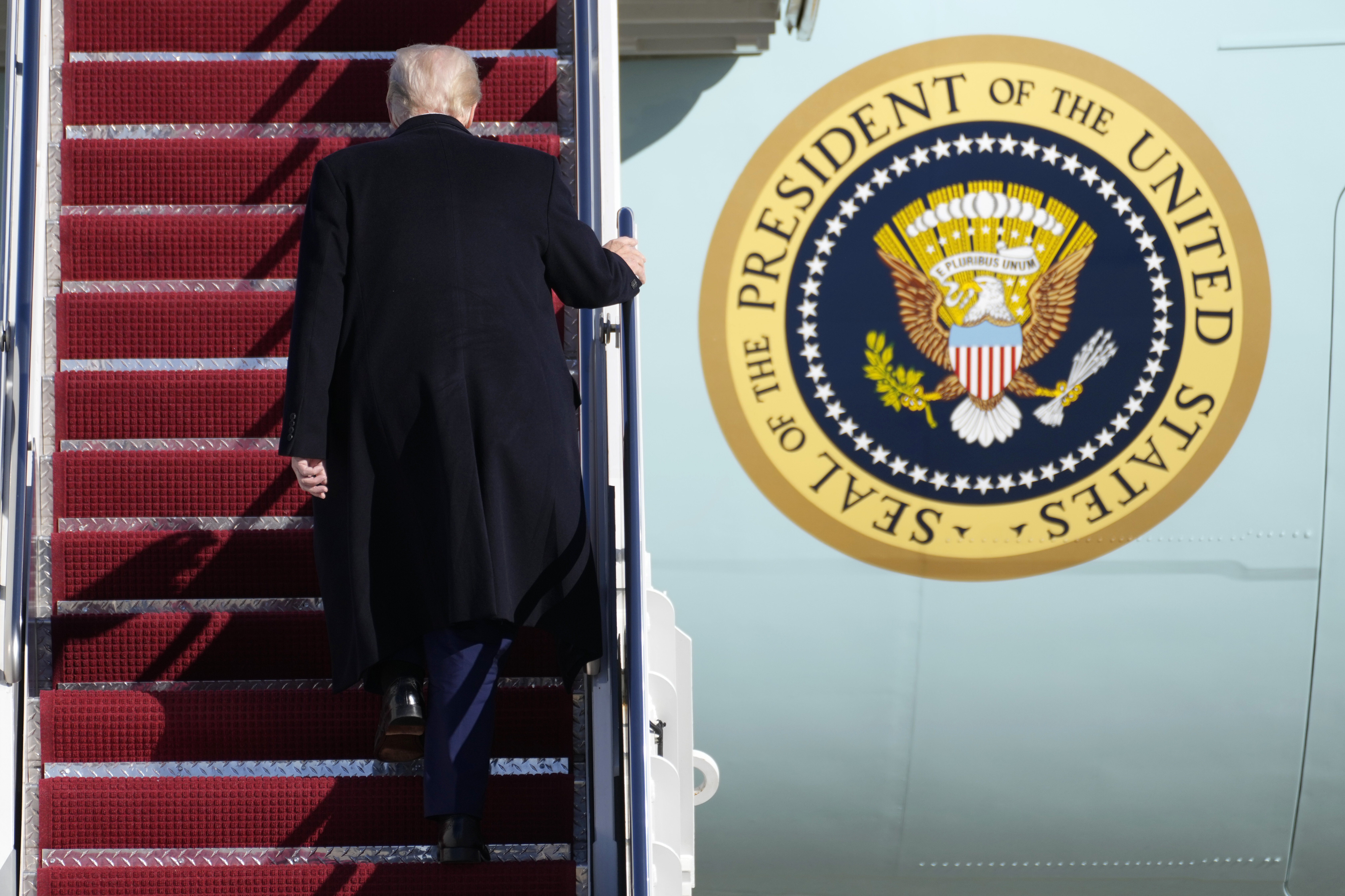 President Donald Trump boards Air Force One at Joint Base Andrews, Md., Friday, Feb. 14, 2025, en route to West Palm Beach, Fla. (AP Photo/Ben Curtis)