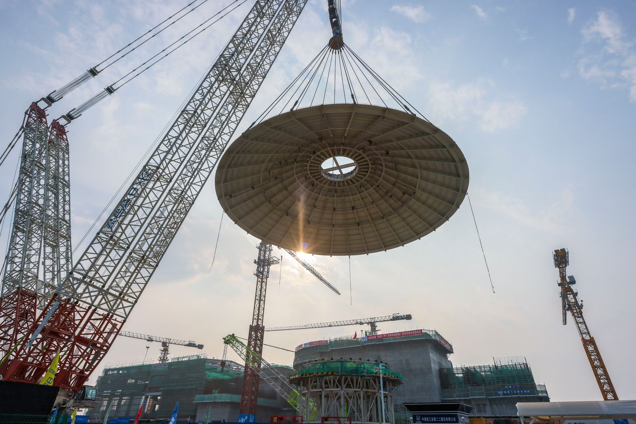 A 550-ton outer dome is hoisted in place at the construction site of the world's first commercial small modular reactor Linglong One, marking the main structure of its reactor building completed, on February 6, 2024 in Changjiang Li Autonomous County, Hainan Province of China. The reactor is expected to generate 1 bln kWh of power annually for 526,000 households upon operation.