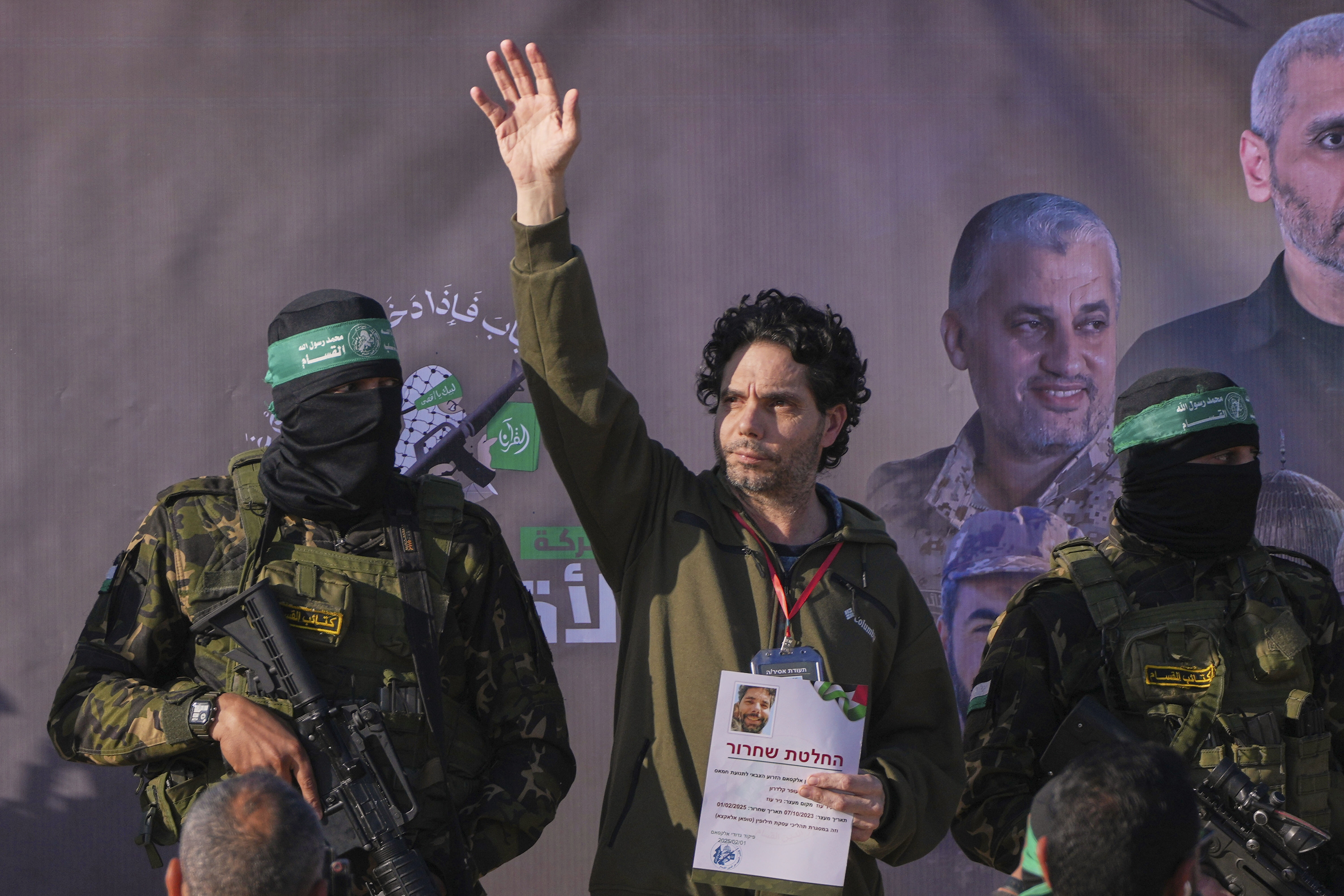 Israeli Ofer Kalderon who has been held hostage by Hamas in Gaza since October 7, 2023, waves before being handed over to the Red Cross by Hamas fighters in Khan Younis, southern Gaza Strip, Saturday Feb. 1, 2025. Photo/Abdel Kareem)