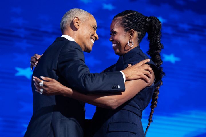 Former President Barack Obama and former first lady Michelle Obama appear on stage in between their addresses on the second night of the Democratic National Convention at the United Center in Chicago, Ill., on Tuesday, August 20, 2024. 