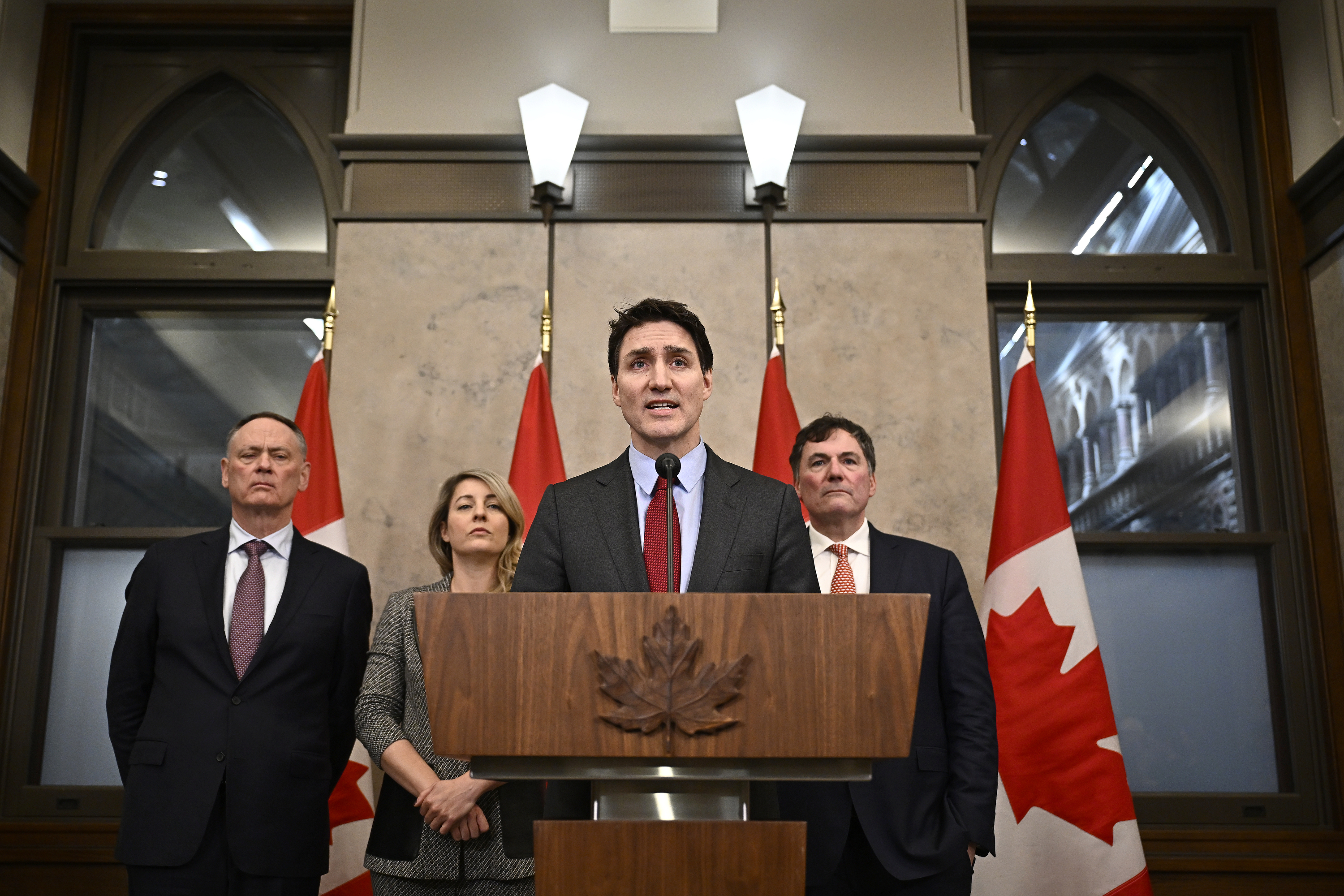 Canada's Prime Minister Justin Trudeau addresses media following the imposition of a raft of tariffs by U.S. President Donald Trump against Canada, Mexico and China, in Ottawa, Saturday, Feb. 1, 2025. Minister of Public Safety David McGuinty, left to right, Global Affairs Minister Melanie Joly and Minister of Governmental Affairs Dominic LeBlanc look on. (Justin Tang/The Canadian Press via AP)