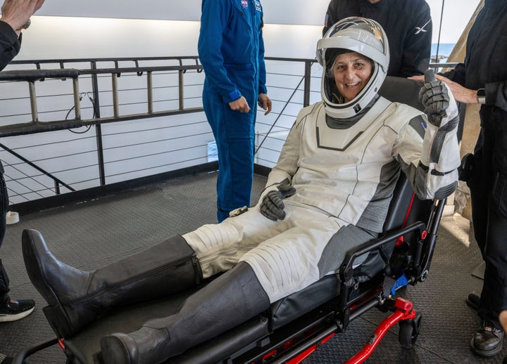 NASA astronaut Suni Williams gives a thumbs-up after being helped out of a SpaceX capsule onboard the SpaceX recovery ship Megan.