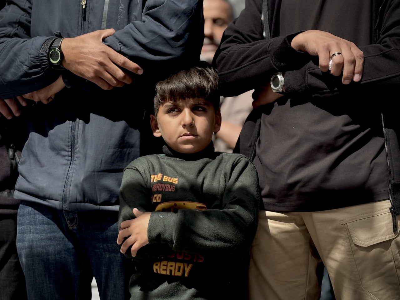 A child who lost his mother attends the funerals of 12 people who were killed in Israeli airstrikes in front of Nasser Hospital in Khan Younis on March 19, 2025. 