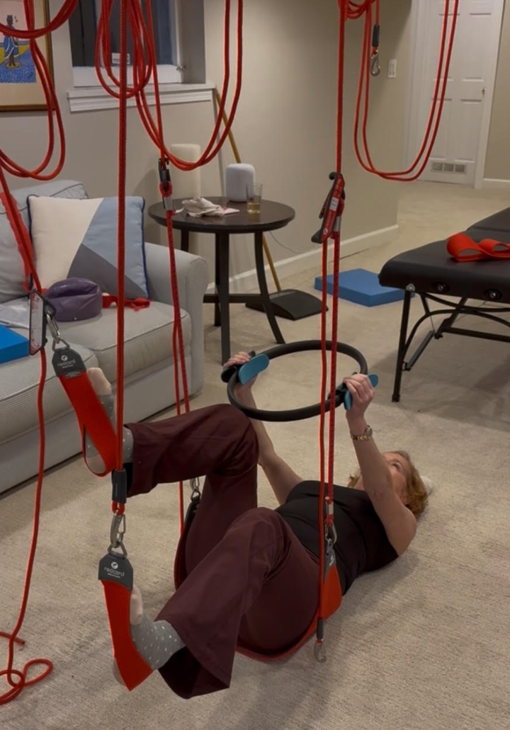 The author strengthens her hypermobile joints using Neurac Redcord in her home, a system of suspended slings and vibration that activates deep stabilizing muscles — ideal for managing joint instability and motor control challenges in Ehlers-Danlos syndrome (EDS).