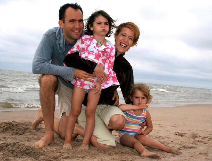 The author and her husband relaxing at the shores of Lake Michigan when their daughters were toddlers.