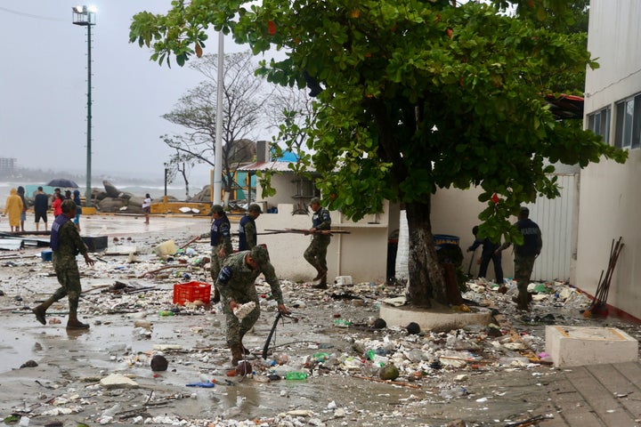 Soldiers clear the street of debris left by Hurricane Erick after it hit near Puerto Escondido, Oaxaca state, Mexico, Thursday, June 19, 2025. (AP Photo/Luis Alberto Cruz)
