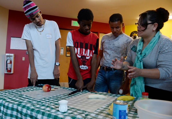Colorado State University Extension teacher Jackie Lopez, right, shows students how to make a fruit salad during a SNAP-Ed food nutrition class in Denver, Colorado, in 2014.