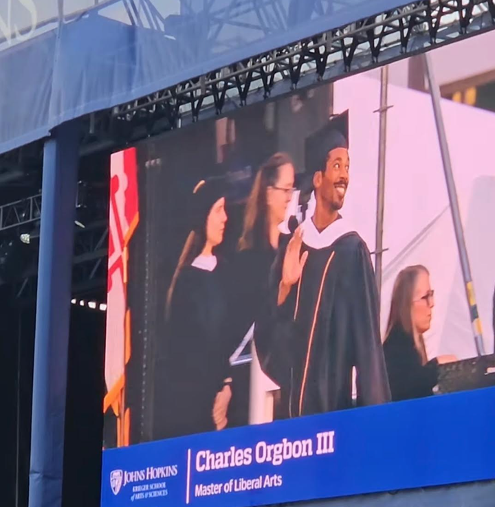 The author is pictured receiving his diploma on graduation day.