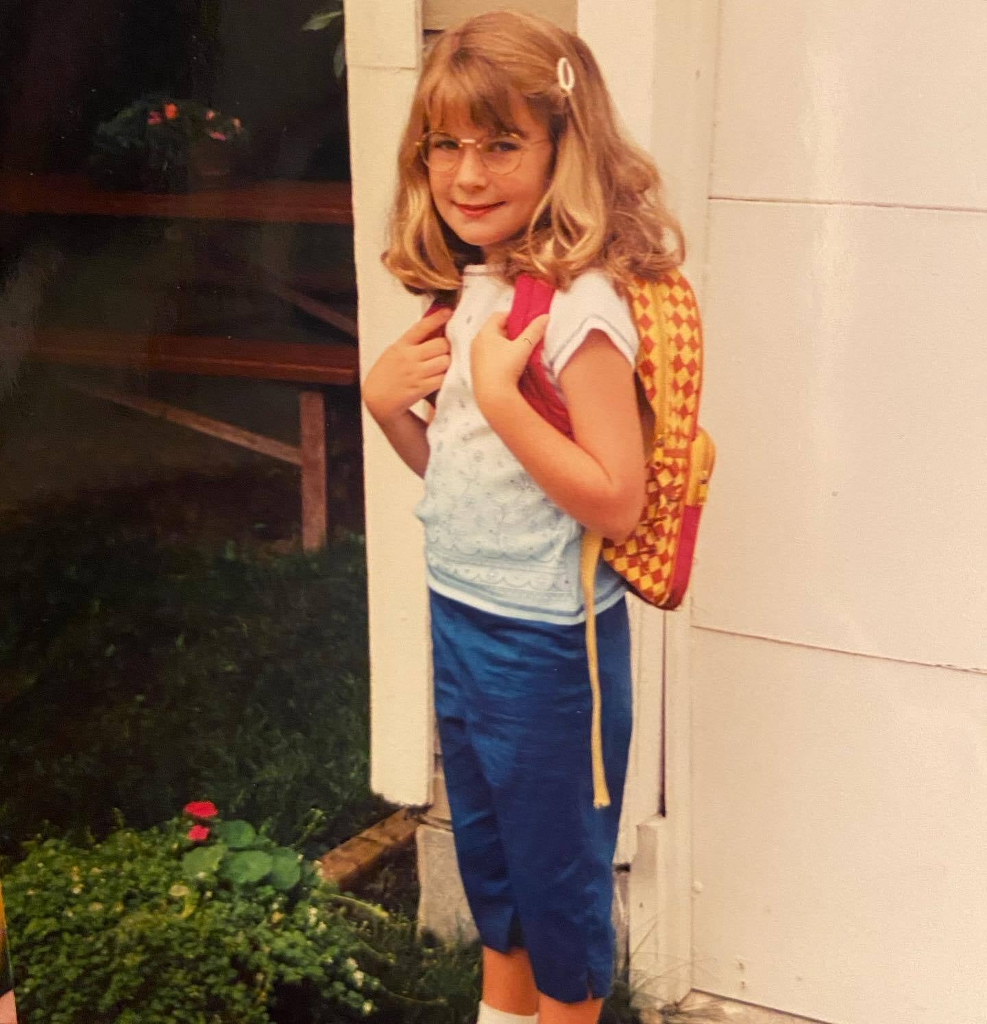 The author poses for an obligatory first day of school photo, wearing a pair of fake glasses that she believed to be VERY cool.