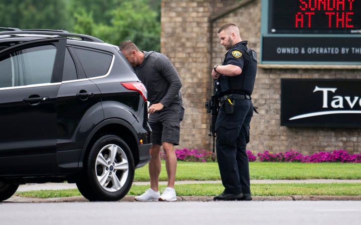 Brooklyn Park police officers search a vehicle entering a neighborhood in Brooklyn Park, Minnesota, on Saturday.