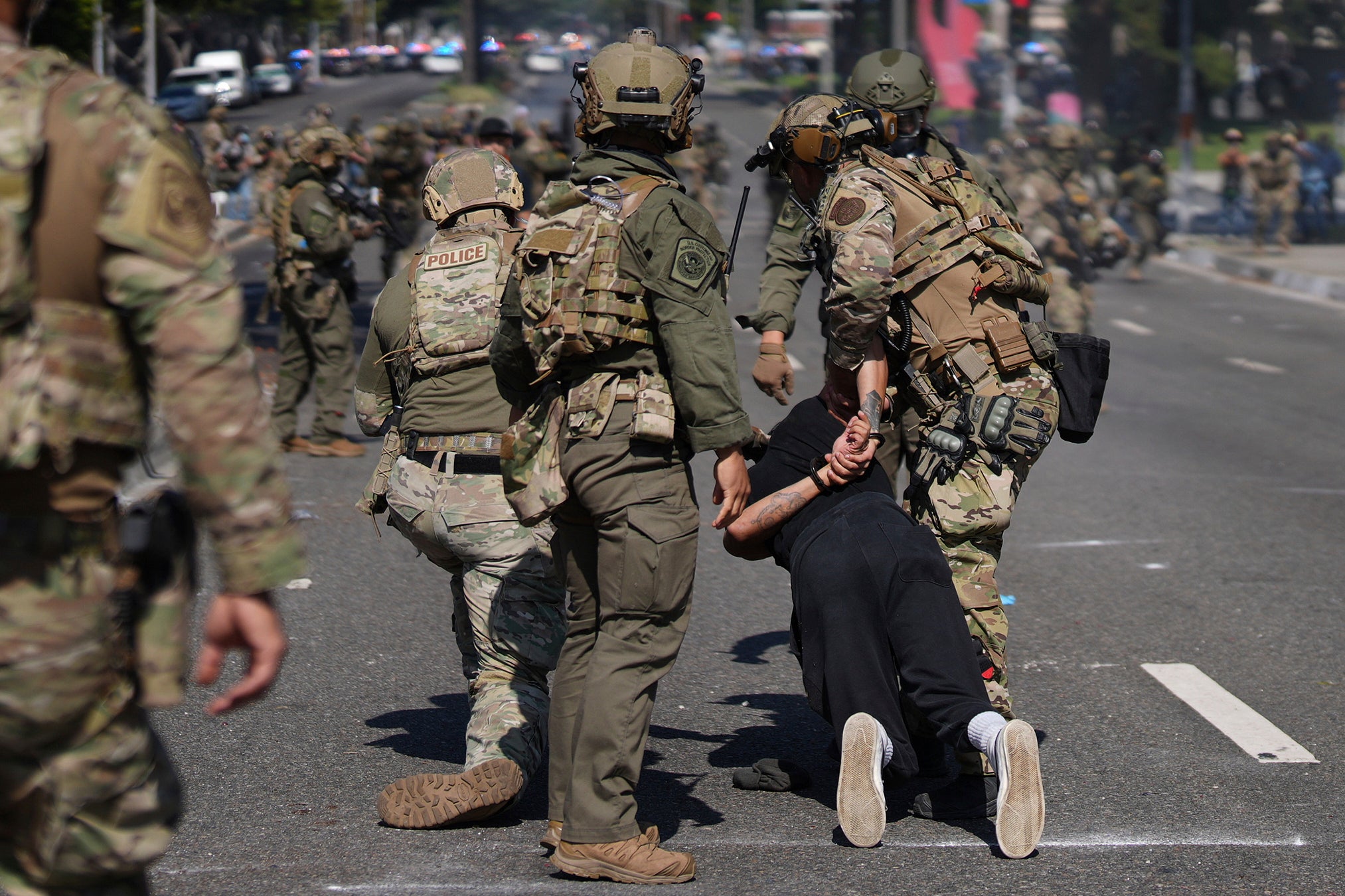 Police detain a man during a protest in Paramount, Calif., Saturday, June 7, 2025, after federal immigration authorities conducted operations. (AP Photo/Eric Thayer)