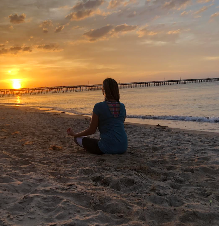 The author meditates at sunset in Virginia Beach, Virginia, about a month after her hysterectomy in February 2016.